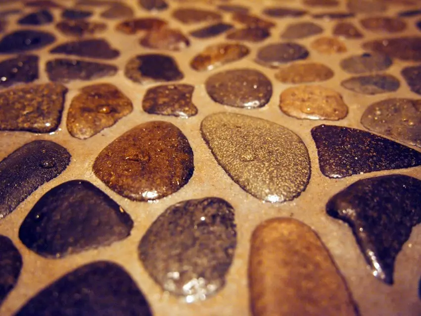 River rock shower floor gives guests a unique foot massage.